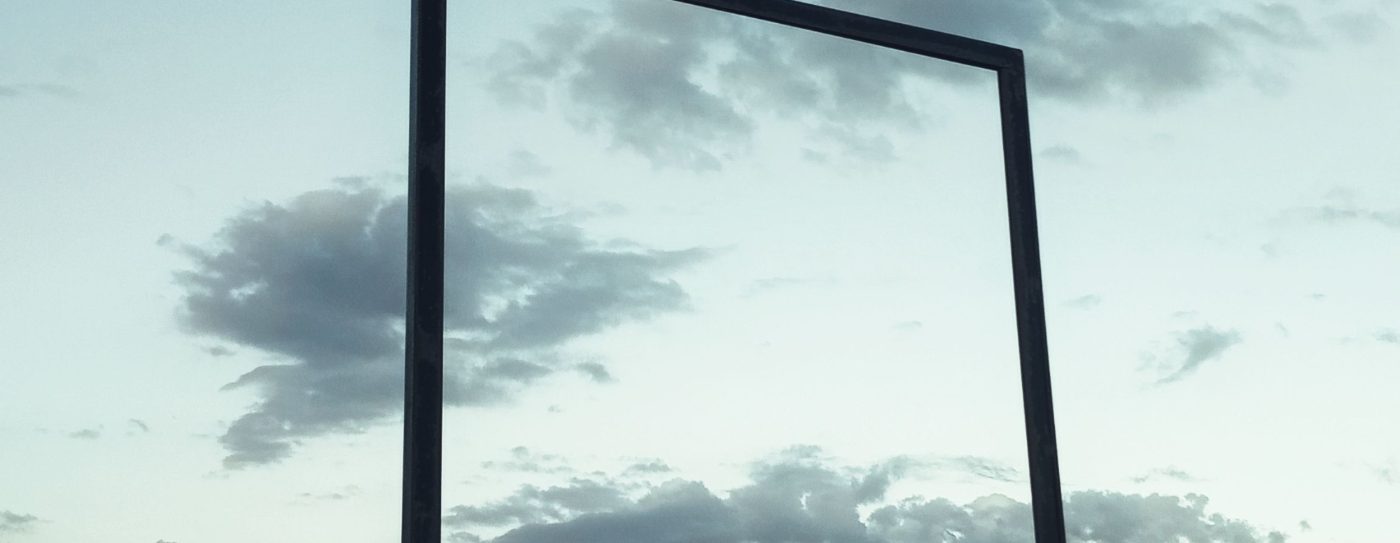 An empty steel frame against cloud